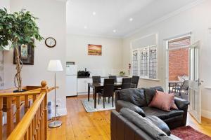 a living room with a couch and a table at Tanunda Central Cottage in Tanunda