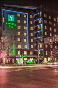 a building with a holiday inn sign at night at Holiday Inn Plovdiv, an IHG Hotel in Plovdiv