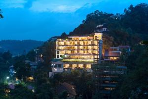 a hotel in the mountains at night at Grand Serendib Hotel in Kandy