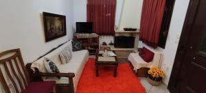 a living room with a couch and a table at Villa Maria in Avdélla