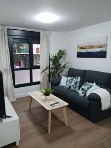 a living room with a couch and a coffee table at Apartamento Central D in Algeciras