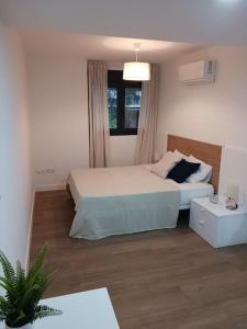a small bedroom with a bed and a window at Apartamento Central D in Algeciras
