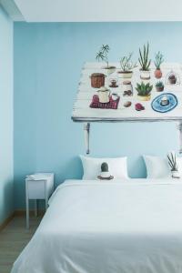 a bed with a shelf with plants on it at Beat Hotel Bangkok in Bangkok