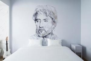 a drawing of a man on a bed in a bedroom at Beat Hotel Bangkok in Bangkok