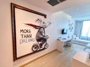 a room with a painting of a rabbit riding a bike at Beat Hotel Bangkok in Bangkok