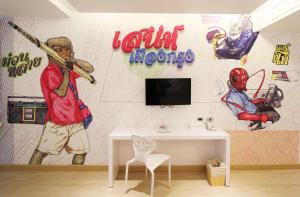 a room with a wall covered in graffiti at Beat Hotel Bangkok in Bangkok