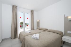 Ένα ή περισσότερα κρεβάτια σε δωμάτιο στο Villas Calan Bosch Tomi