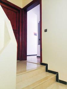 an empty hallway with stairs and a door at Hammadi's house in Oualidia