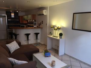 a living room with a couch and a table at Appartement Esterelle in Cassis