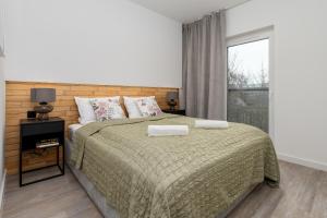 Posteľ alebo postele v izbe v ubytovaní CityCenterApartments-11/19