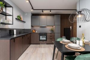 a kitchen and dining room with a table and chairs at CityCenterApartments-11/19 in Bielsko-Biala
