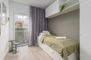 a small bedroom with a bed and a window at CityCenterApartments-11/19 in Bielsko-Biała