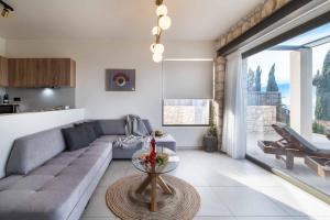 a living room with a couch and a table at Villa Orion in Tsoukaladhes