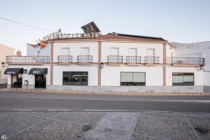 a white building on the side of a street at Hostal Rio in Medellín