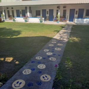 a garden with face faces painted on the grass at Spacious Resort in Pansol up to 20 pax in Pansol