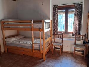 a room with two bunk beds and a window at La Casona de la Luz in Guadix