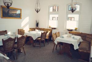 a dining room with two tables and chairs in a restaurant at Pension Morgenweck in Bad Salzungen