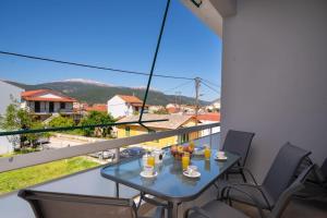 a table and chairs on a balcony with a view at Vasilakis Apartment in Sami