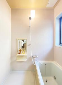 a bathroom with a bath tub and a mirror at The Domain in Kochi