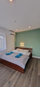 a bedroom with a large bed with two blue towels on it at Villa Field6 in Révfülöp +44 photos