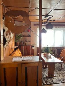 a room with a table and a donut hanging from the ceiling at Retro chata na Čupku in Metylovice