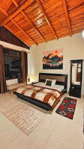 a bedroom with a large bed in a room at Meraki - Entire 2BHK Villa With Himalayan Views in Rānīkhet