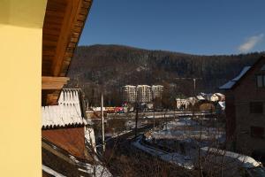 a view of a town with a train track in the snow at Oskolok Dovbusha Mini-Hotel in Yaremche