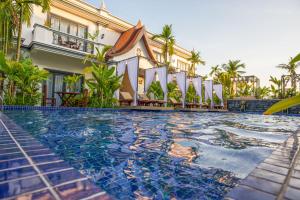 a swimming pool in front of a building at Angkor Tempora Boutique in Siem Reap