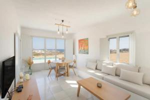 a living room with a couch and a table at Maisonette Sail in Naousa