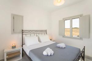 a bedroom with a bed with towels on it at Maisonette Sail in Naousa +33 photos