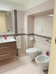 a bathroom with a toilet and a sink and a mirror at Casa Marilisa in Maiori