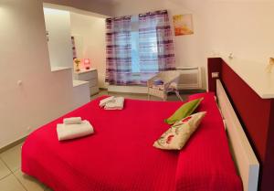 a bedroom with a red bed with towels on it at Casa Marilisa in Maiori