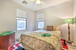a bedroom with a bed and a dresser and two windows at Fire Table, Grill Surprise Cottage with Pool Access in Surprise +23 photos