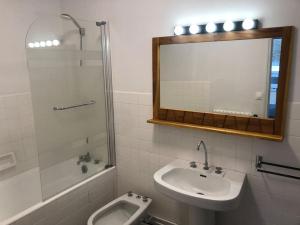 a bathroom with a sink and a toilet and a mirror at La Caravelle au plus près de la mer in Saint Malo