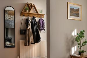 a hallway with a coat rack and a radiator at Finest Retreats - Bwthyn Llechi, Slate Cottage in Blaenau-Ffestiniog +17 photos