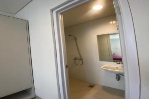 a bathroom with a sink and a mirror at EXPRESS O 92155 Nia Residence 2 in Tegal