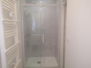 a shower with a glass door in a bathroom at Cosy Appartement Near Luxembourg in Hayange