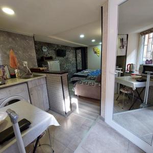 a room with a kitchen and a living room at Beqa house in Tbilisi City