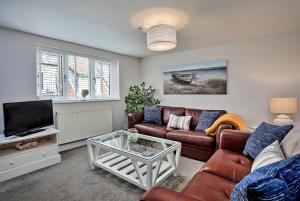 een woonkamer met een bank en een tv bij Finest Retreats - Old Salt Loft in Whitby