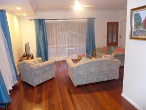 a living room with two chairs and a couch at Rural Ambience with Netflix in Mount George