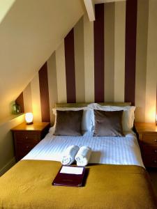 a bedroom with a bed with a book on it at Salisbury Guest House in Keswick