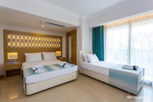 Postel nebo postele na pokoji v ubytování Aurasia Design Hotel