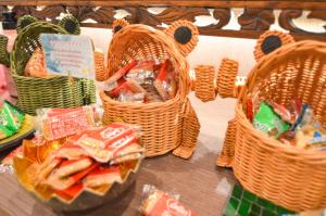a table with baskets of food and snacks on it at Hotel BaliBali 伊勢佐木 in Yokohama