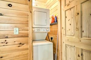 a kitchen with a washer and dryer in a wooden wall at Cozy Cabin in Parsons Hike, Fish and Explore! in Parsons