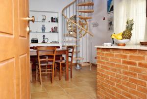 a kitchen and dining room with a table and chairs at Residenza Le Sirene in Santa Domenica