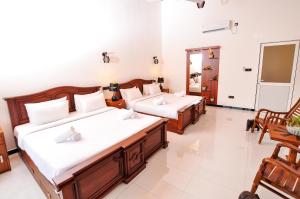 Letto o letti in una camera di Sachinro Hotel Mirissa