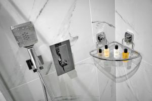a shower with a glass shelf with bottles of wine at Finest Retreats - The Bank House in Boroughbridge +18 photos