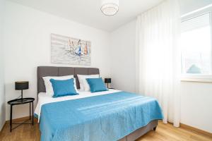 - une chambre avec un lit et une couverture bleue dans l'établissement Apartment Zoric, à Dubrovnik