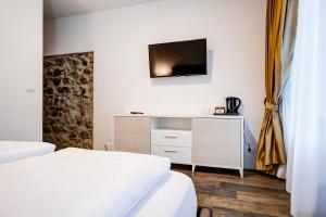 Postel nebo postele na pokoji v ubytování Arcadia Rooms