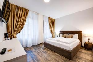 Postel nebo postele na pokoji v ubytování Arcadia Rooms